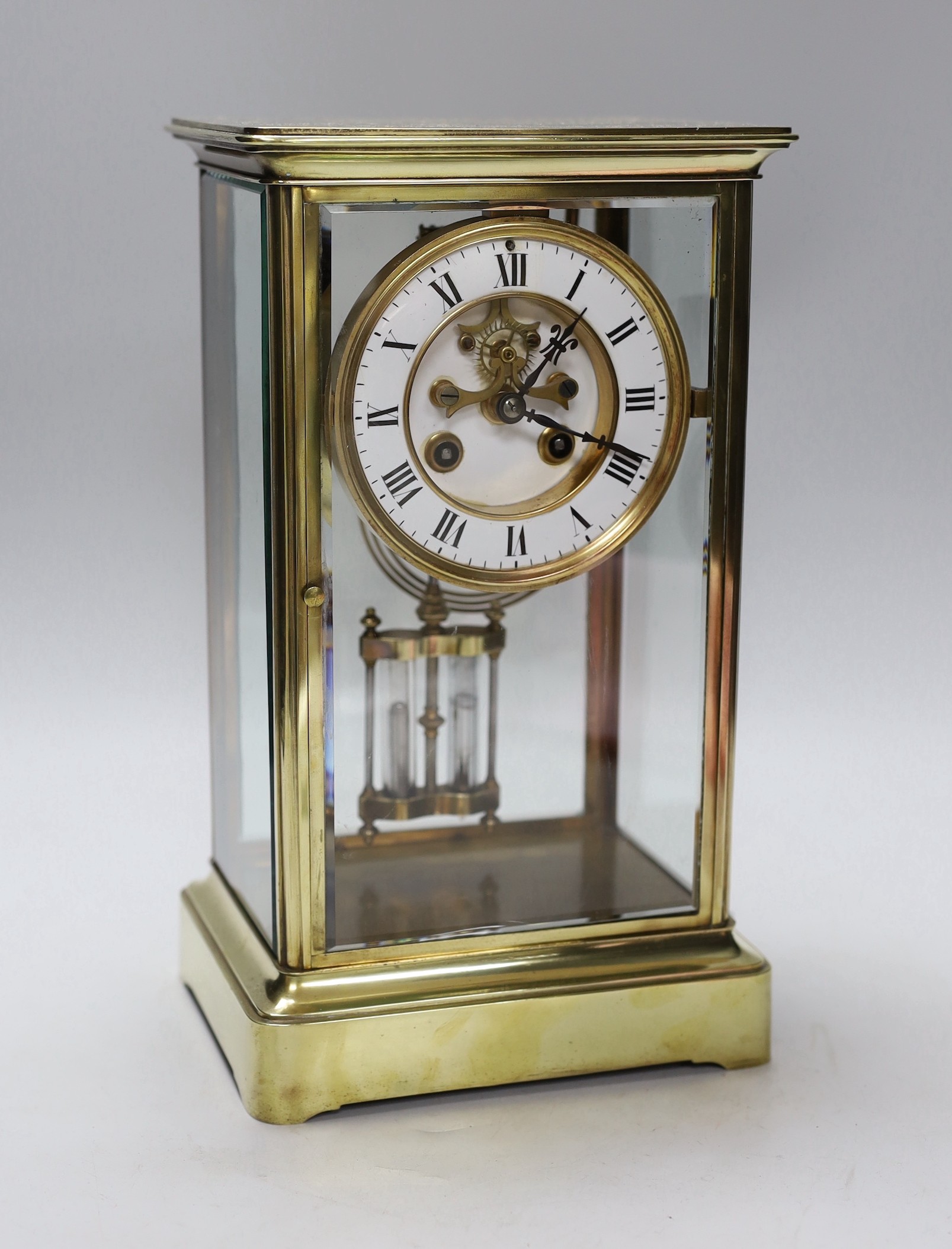 A late 19th century brass and four glass mantel clock, 30cm high